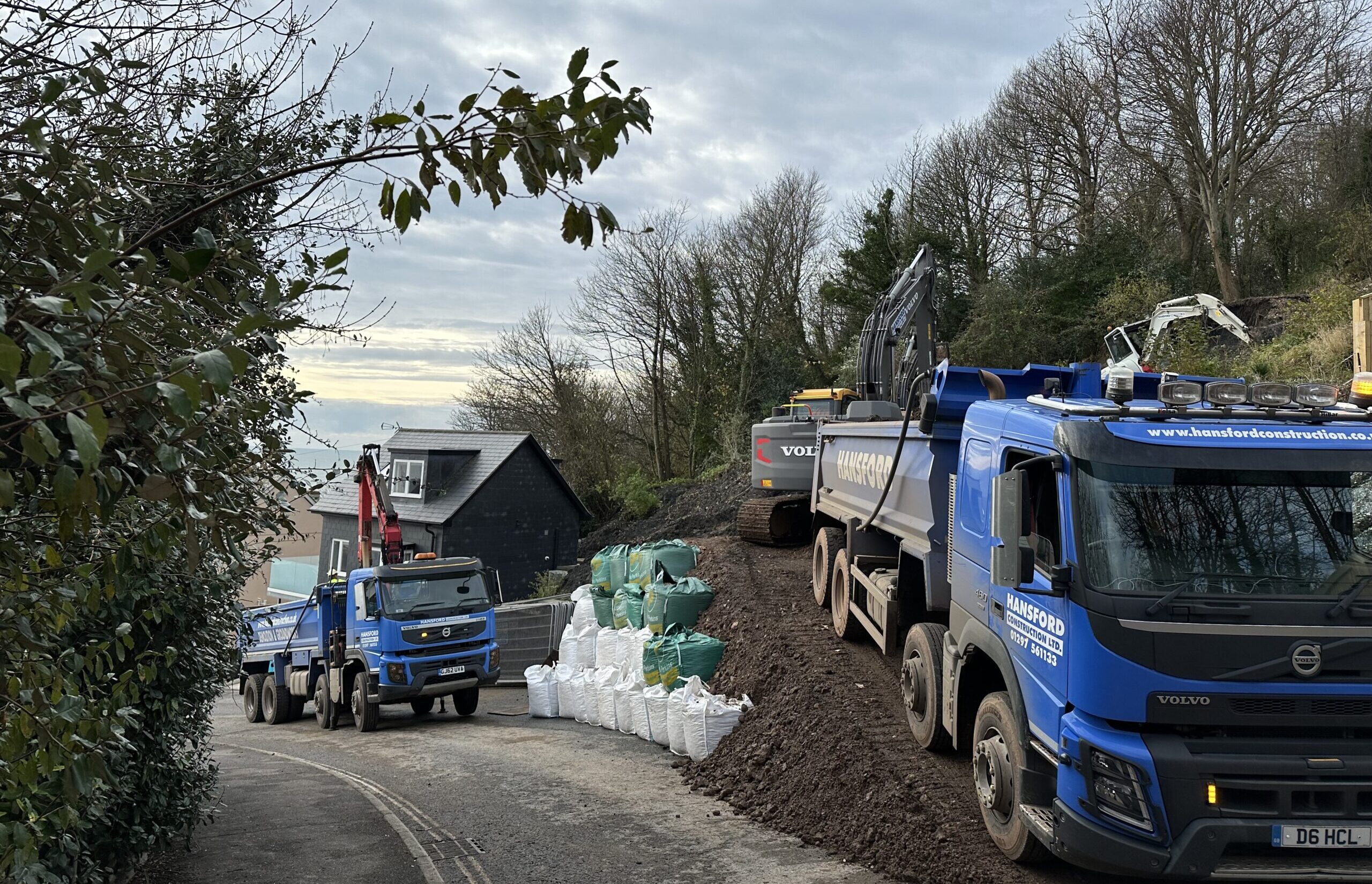 Grab lorry transporting material during emergency groundworks and landslip repair in Lyme Regis