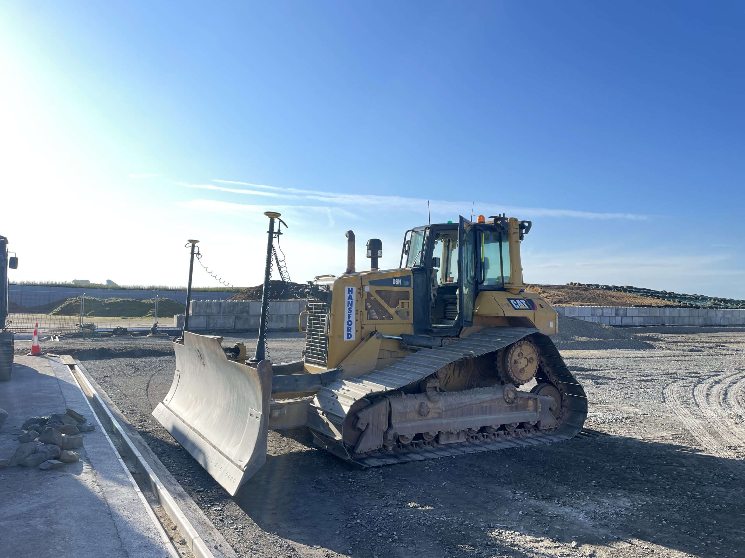 Bulldozer grading silage clamp base with GPS-controlled machinery in North Devon