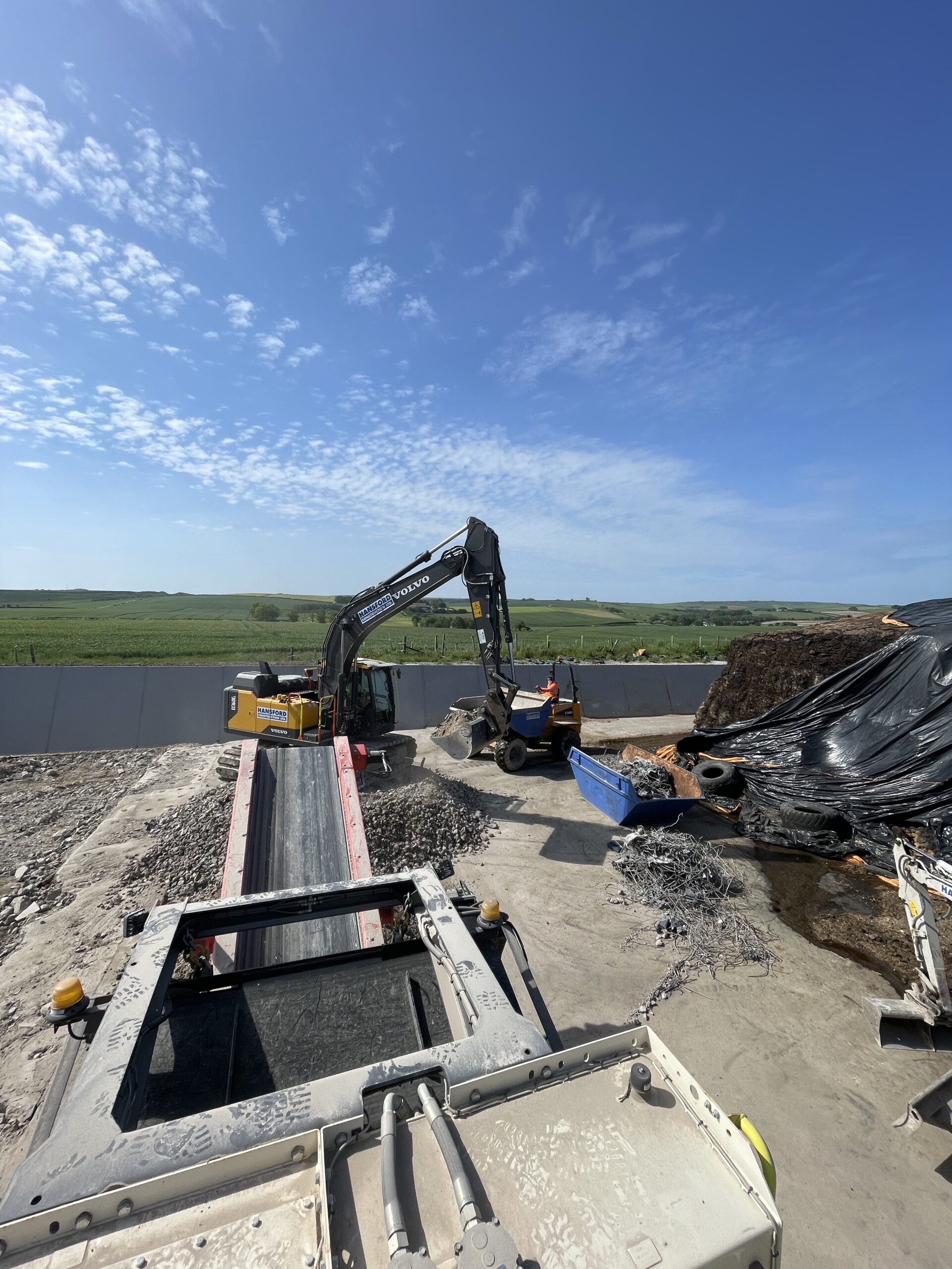 Excavator and groundwork machinery during foundation and drainage works in Dorset